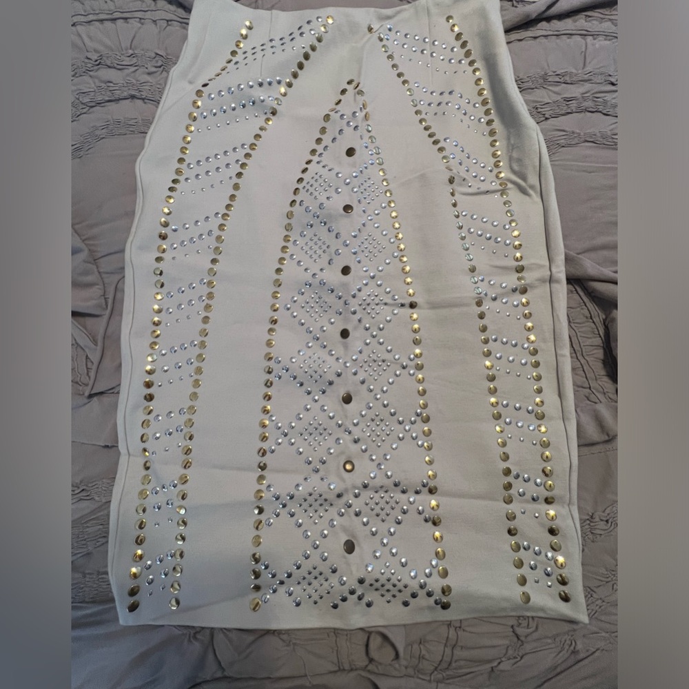 Body by Victoria color is a beige/cream studs are silver & gold